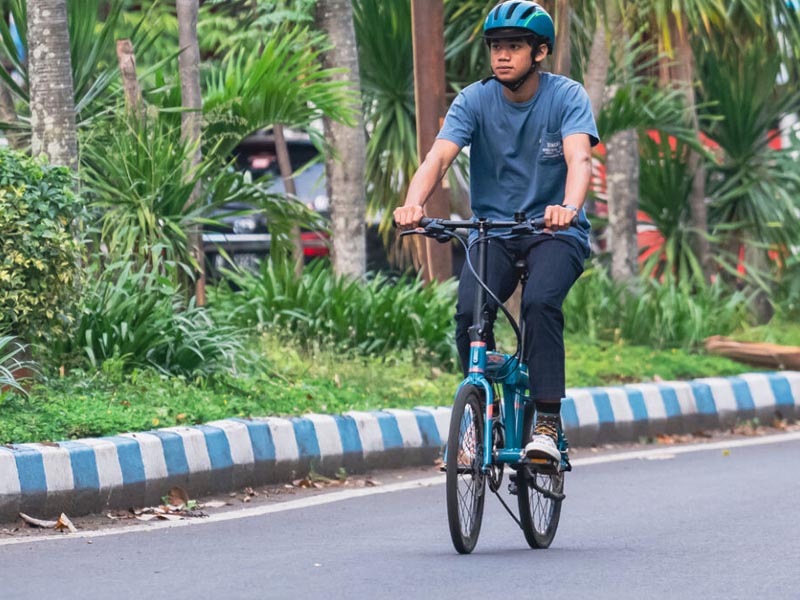 A young rider cycling in the morning using a Polygon folding bike A young rider cycling in the morning using a Polygon folding bike