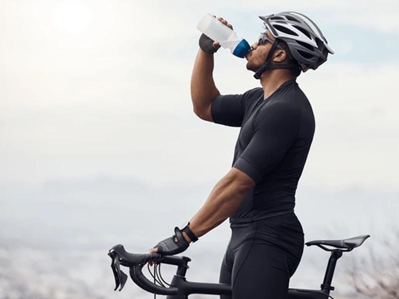 A cyclist maintains his proper nutrition before a road bike race A cyclist maintains his proper nutrition before a road bike race