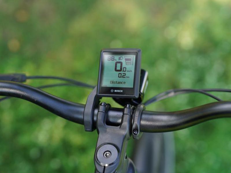 A detailed view of a bike computer shows the bike speed and distance range based on the battery remaining A detailed view of a bike computer shows the bike speed and distance range based on the battery remaining