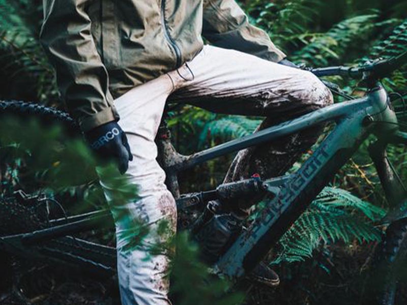 Mountain biker covered in mud after passing through the muddy track Mountain biker covered in mud after passing through the muddy track