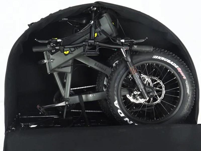 A black foldable bike in a compact folded state and about to be carried inside a travel case A black foldable bike in a compact folded state and about to be carried inside a travel case