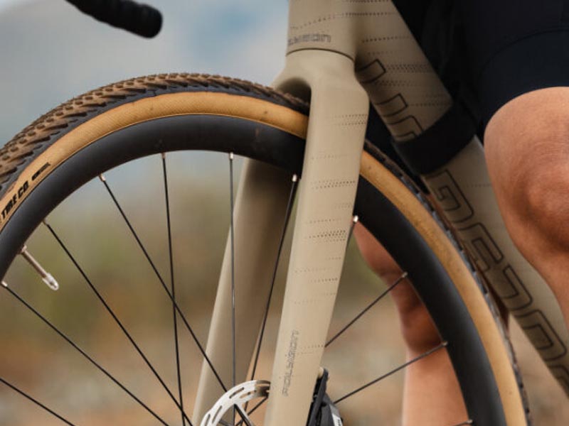 A close-up view of the gravel bike tire clearance showing the tire, fork, and the down tube A close-up view of the gravel bike tire clearance showing the tire, fork, and the down tube