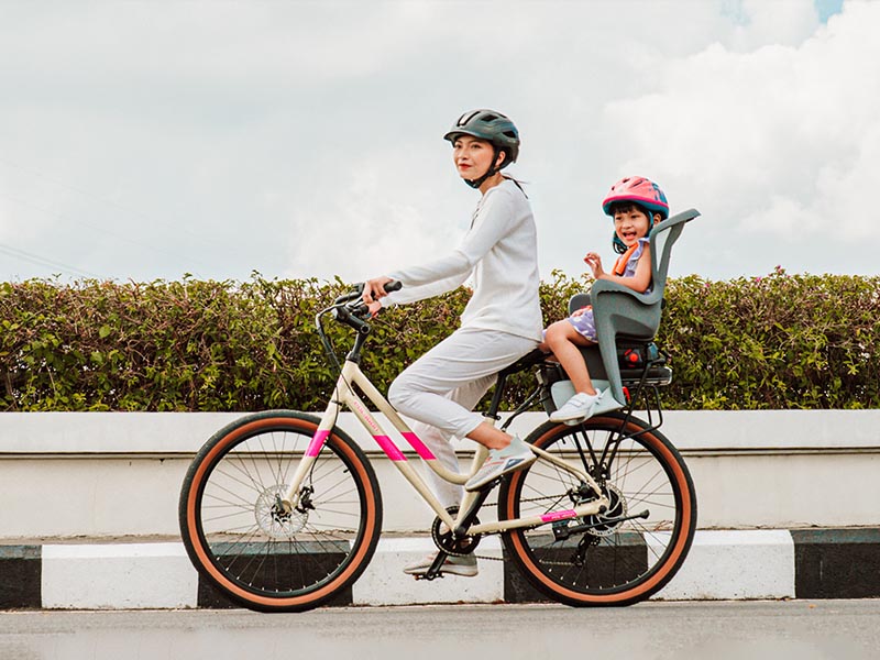 Mom and her daughter cycling together using a kids-friendly urban bike Mom and her daughter cycling together using a kids-friendly urban bike