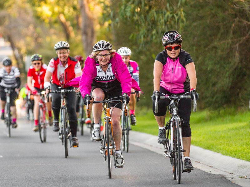 Road biking group activity by adult women road bike community in the morning Road biking group activity by adult women road bike community in the morning