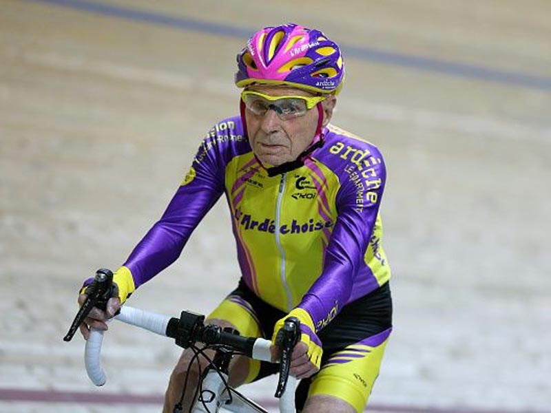 An Old man actively maintains his health by cycling An Old man actively maintains his health by cycling