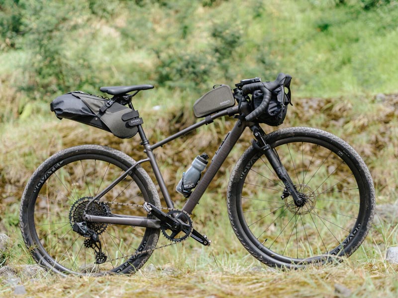 A gravel bike fully equipped with bags and a bottle cage A gravel bike fully equipped with bags and a bottle cage