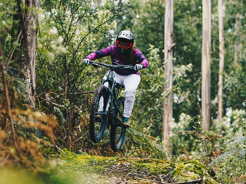 A female mountain biker conquers the mountain track A female mountain biker conquers the mountain track