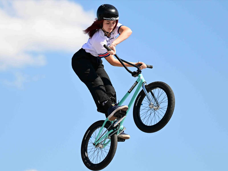 Female cyclist perform with her BMX Bikes Female cyclist perform with her BMX Bikes