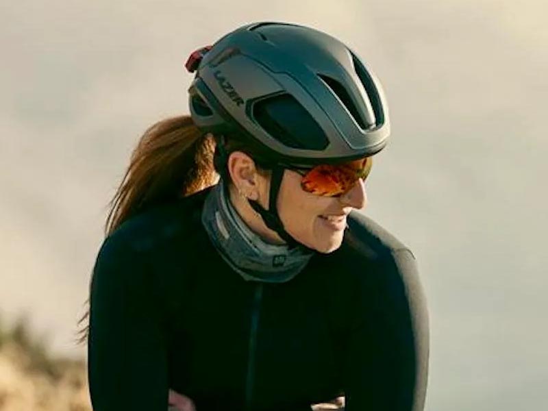 A female cyclist with essential gear wore a bike helmet and sunglasses A female cyclist with essential gear wore a bike helmet and sunglasses