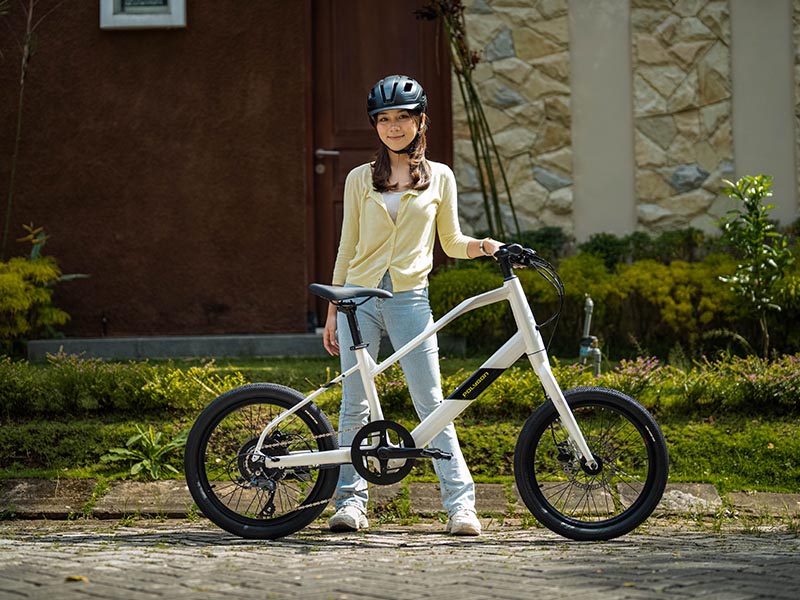 A woman cyclist holding her beautiful Polygon Gili Velo A woman cyclist holding her beautiful Polygon Gili Velo