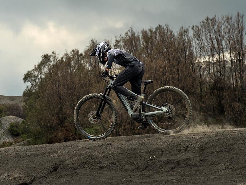 A mountain cyclist navigating descending tracks with an electric mountain bicycles A mountain cyclist navigating descending tracks with an electric mountain bicycles