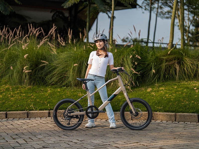 A woman with her compact mini velo electric bike A woman with her compact mini velo electric bike