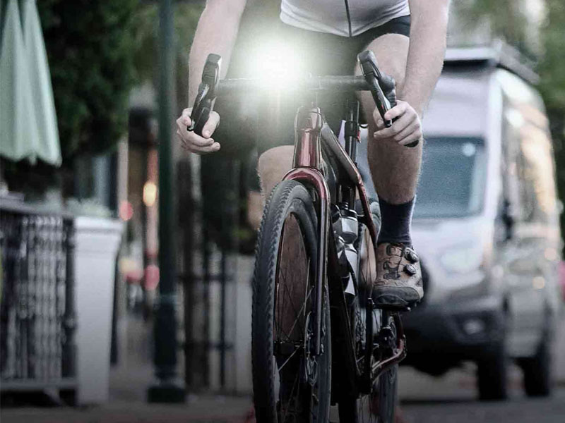 A cyclist going through the darkness with bike lights A cyclist going through the darkness with bike lights