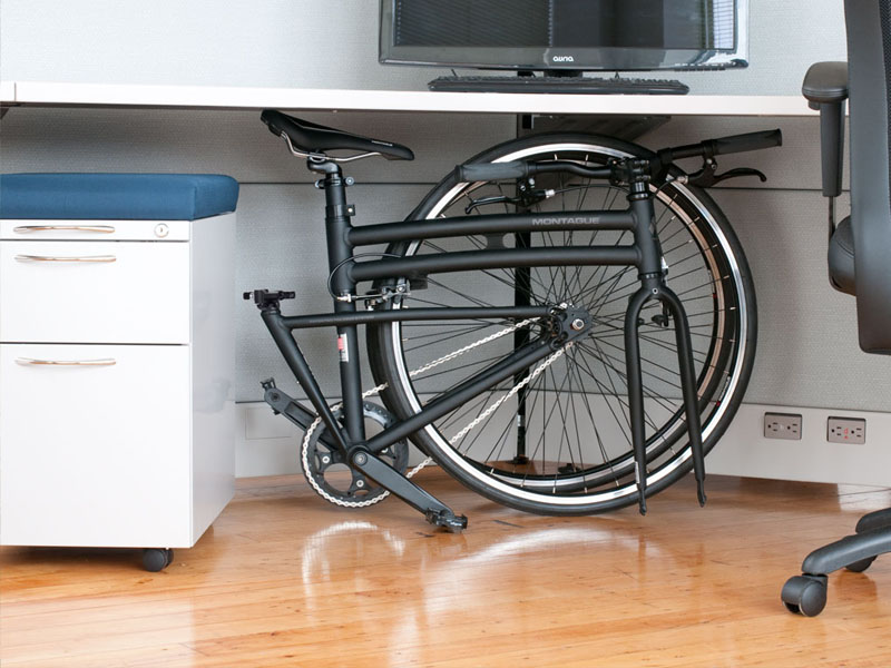A Foldable bike is stored under the table A Foldable bike is stored under the table