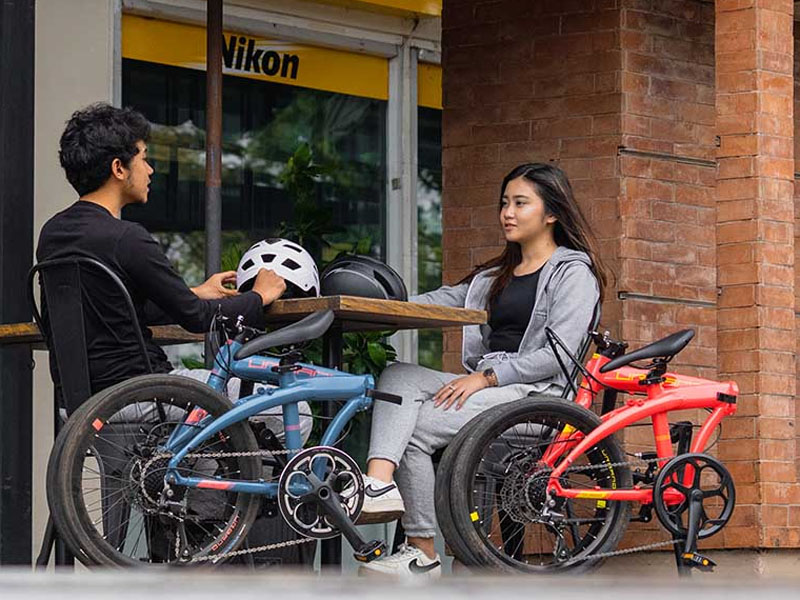 Riders enjoy a break along with their foldable bikes Riders enjoy a break along with their foldable bikes