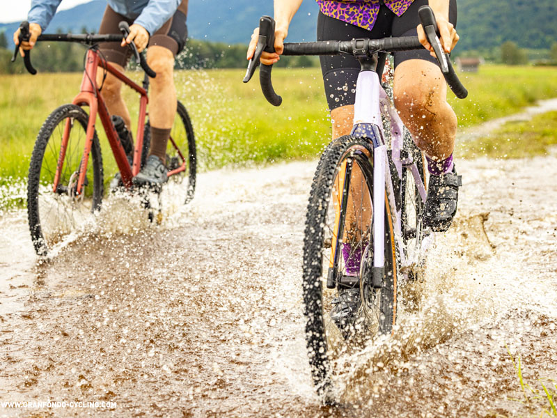 A gravel cyclist takes a challenge by passing through the muddy tracks A gravel cyclist takes a challenge by passing through the muddy tracks