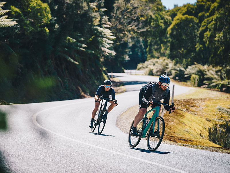 A gravel cyclist cornering on the sharp bend A gravel cyclist cornering on the sharp bend