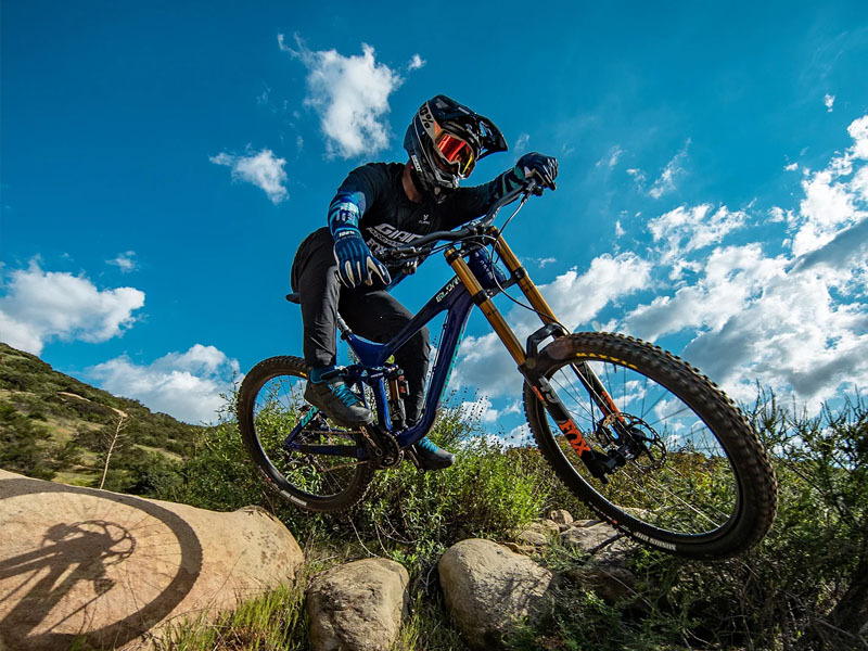 A mountain cyclist jumps a little on rocky terrains A mountain cyclist jumps a little on rocky terrains