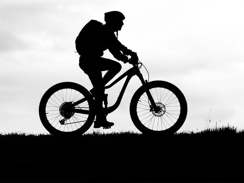 Mountain cyclist silhouette in the evening Mountain cyclist silhouette in the evening