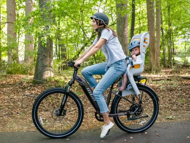 A child enjoying her moment riding with her mom A child enjoying her moment riding with her mom