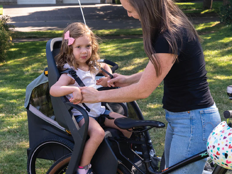 A child is prepared to sit on the back bike child seats A child is prepared to sit on the back bike child seats