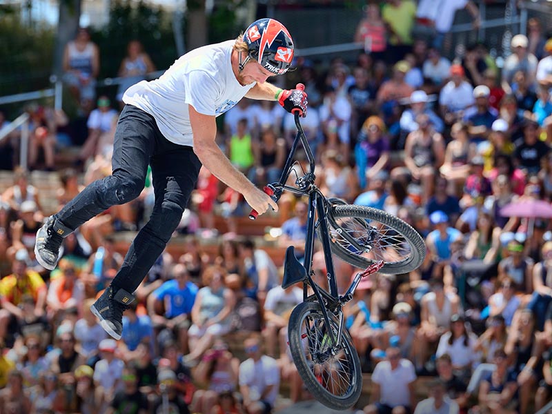 A BMX cyclist shows off his skills with BMX Flatland A BMX cyclist shows off his skills with BMX Flatland