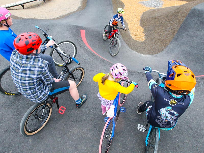 A BMX Park cyclist performs in the city park A BMX Park cyclist performs in the city park