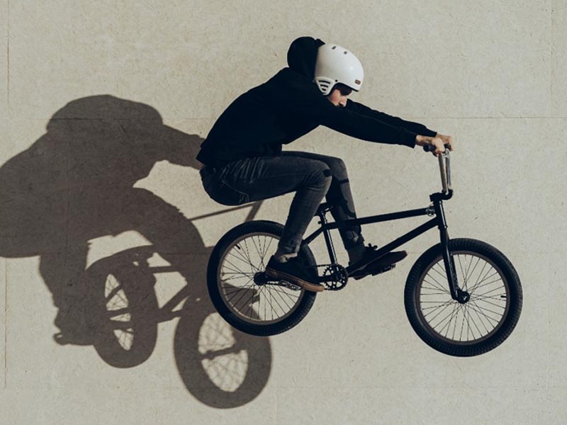 A BMX cyclist perfectly did bunny hop trick A BMX cyclist perfectly did bunny hop trick