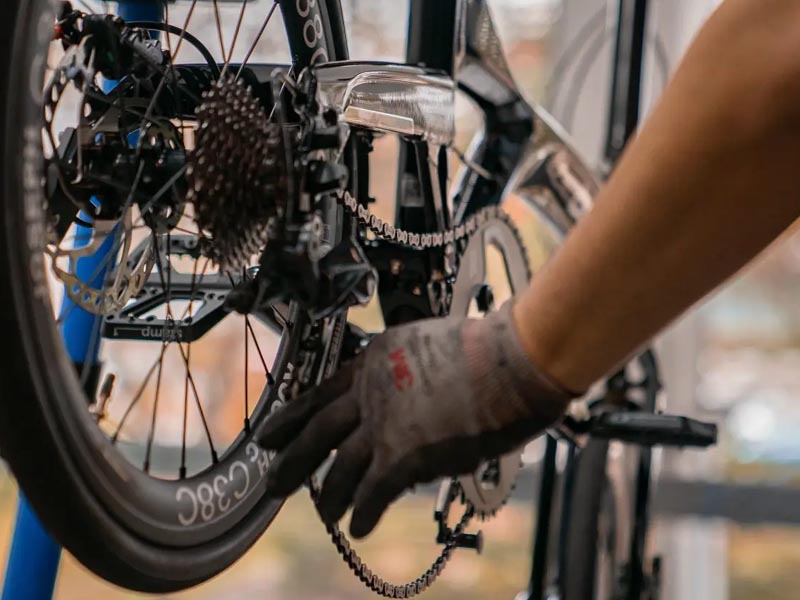 A cyclist routinely maintains his folding bike A cyclist routinely maintains his folding bike