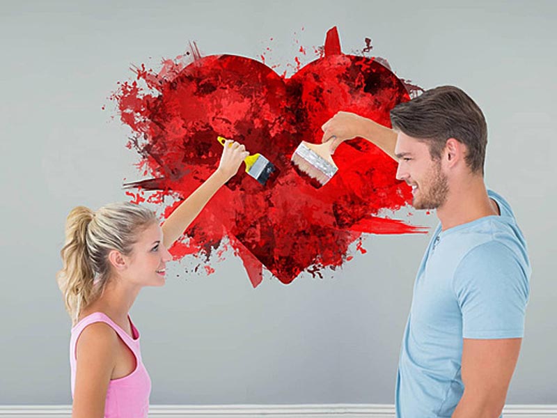 A couple painting together unleashing their creative side A couple painting together unleashing their creative side