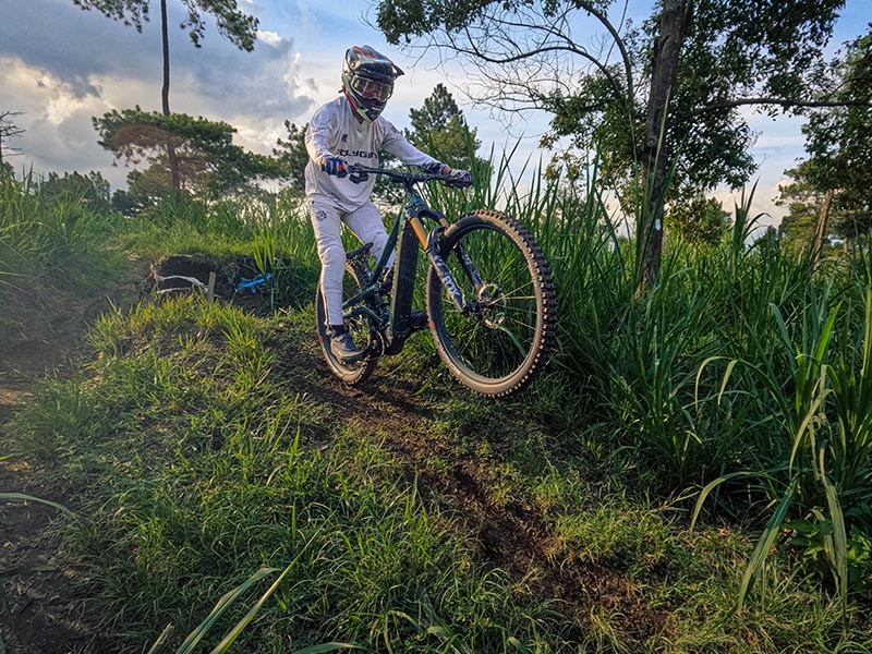 A mountain cyclist rides his electric mountain bike through the park A mountain cyclist rides his electric mountain bike through the park
