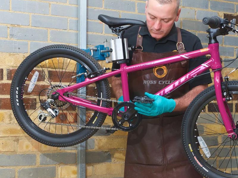 A cyclist routinely maintains his BMX Bike A cyclist routinely maintains his BMX Bike