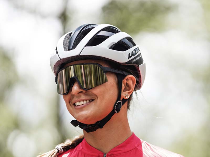 Wanita sedang mengenakan helm sepeda Wanita sedang mengenakan helm sepeda