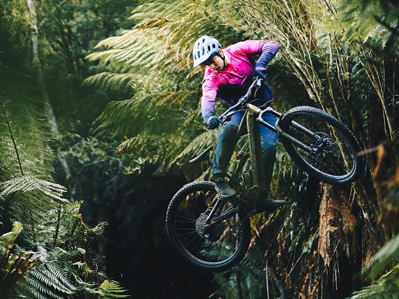 A mountain cyclist jumping with an electric mountain bike A mountain cyclist jumping with an electric mountain bike