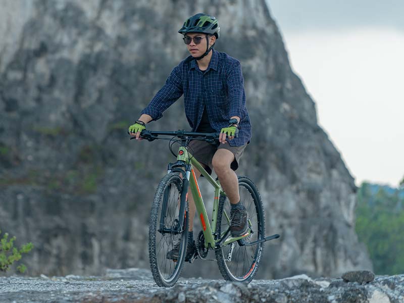 Riding a hybrid bike on a rocky surface Riding a hybrid bike on a rocky surface