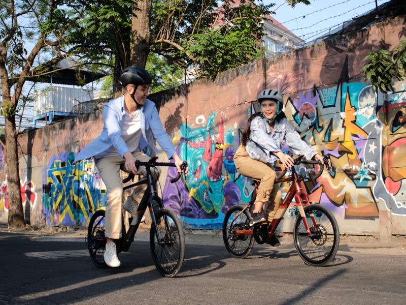 A couple enjoying a leisure ride with electric mini velo bikes A couple enjoying a leisure ride with electric mini velo bikes