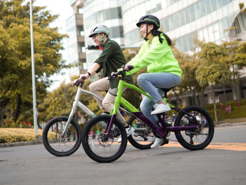 Couple cyclist enjoying the city with electric mini velo bike Couple cyclist enjoying the city with electric mini velo bike