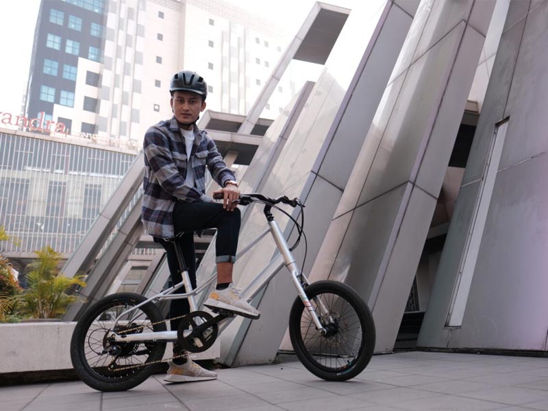 Urban cyclist with his Polygon Gili Velo electric mini velo bike Urban cyclist with his Polygon Gili Velo electric mini velo bike