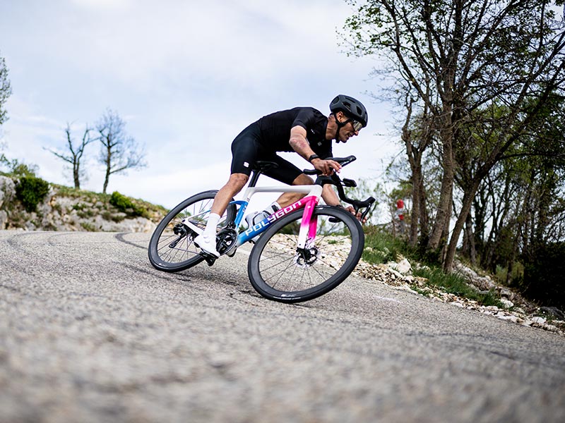A road cyclist cruising over smooth pavement A road cyclist cruising over smooth pavement