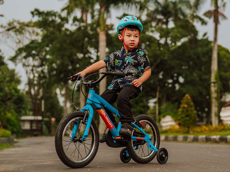 Kids with his four-wheel bike Kids with his four-wheel bike