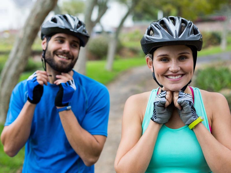 A bike helmet is hold by a cyclist A bike helmet is hold by a cyclist