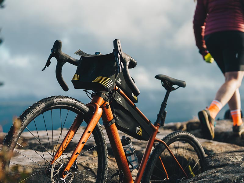 A gravel bike is standing over the gravel road A gravel bike is standing over the gravel road
