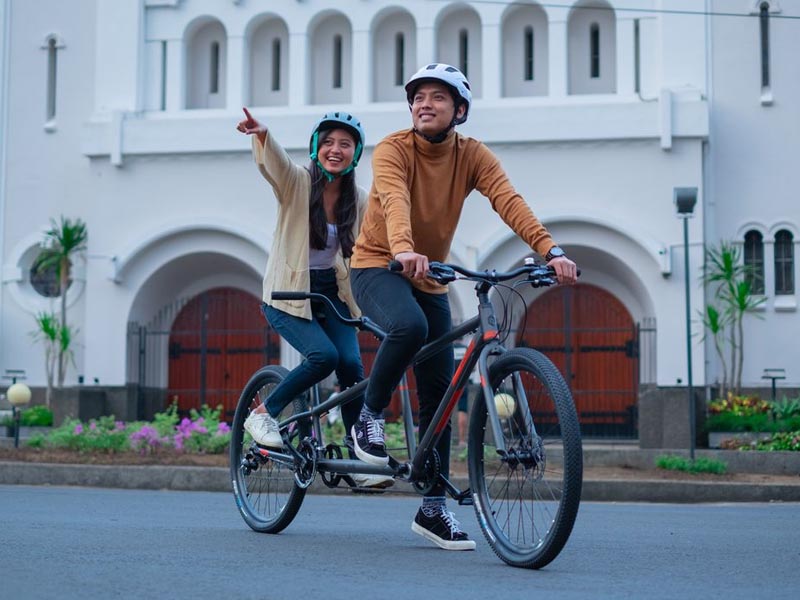 A couple cycling together celebrating Valentine day A couple cycling together celebrating Valentine day